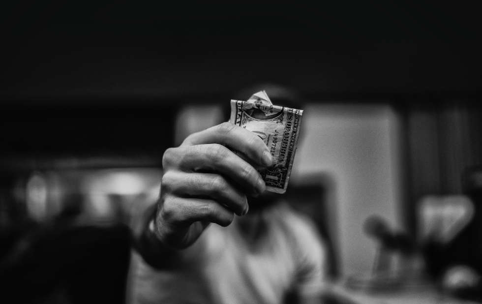 Man holding money generated through email marketing