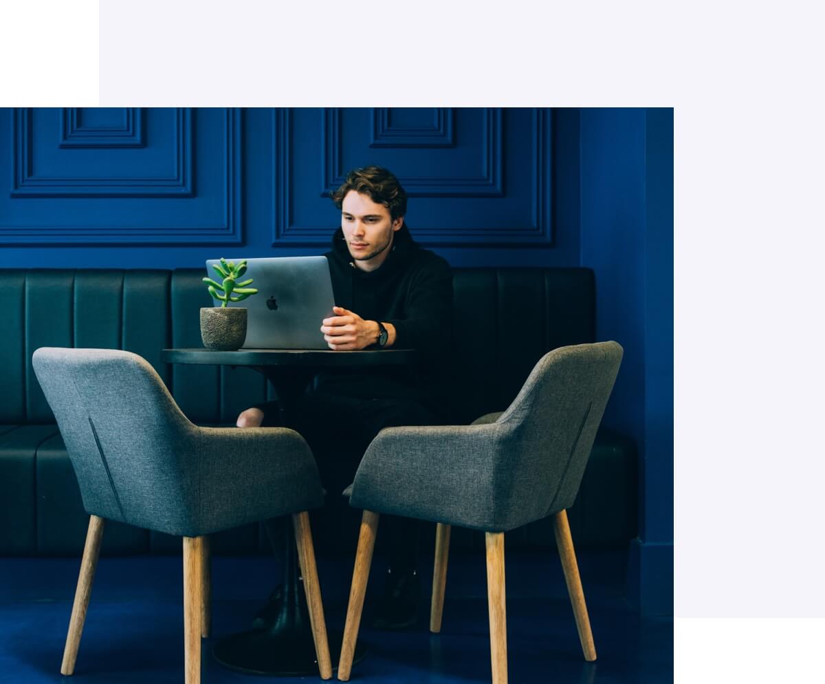Man at table working on Mac