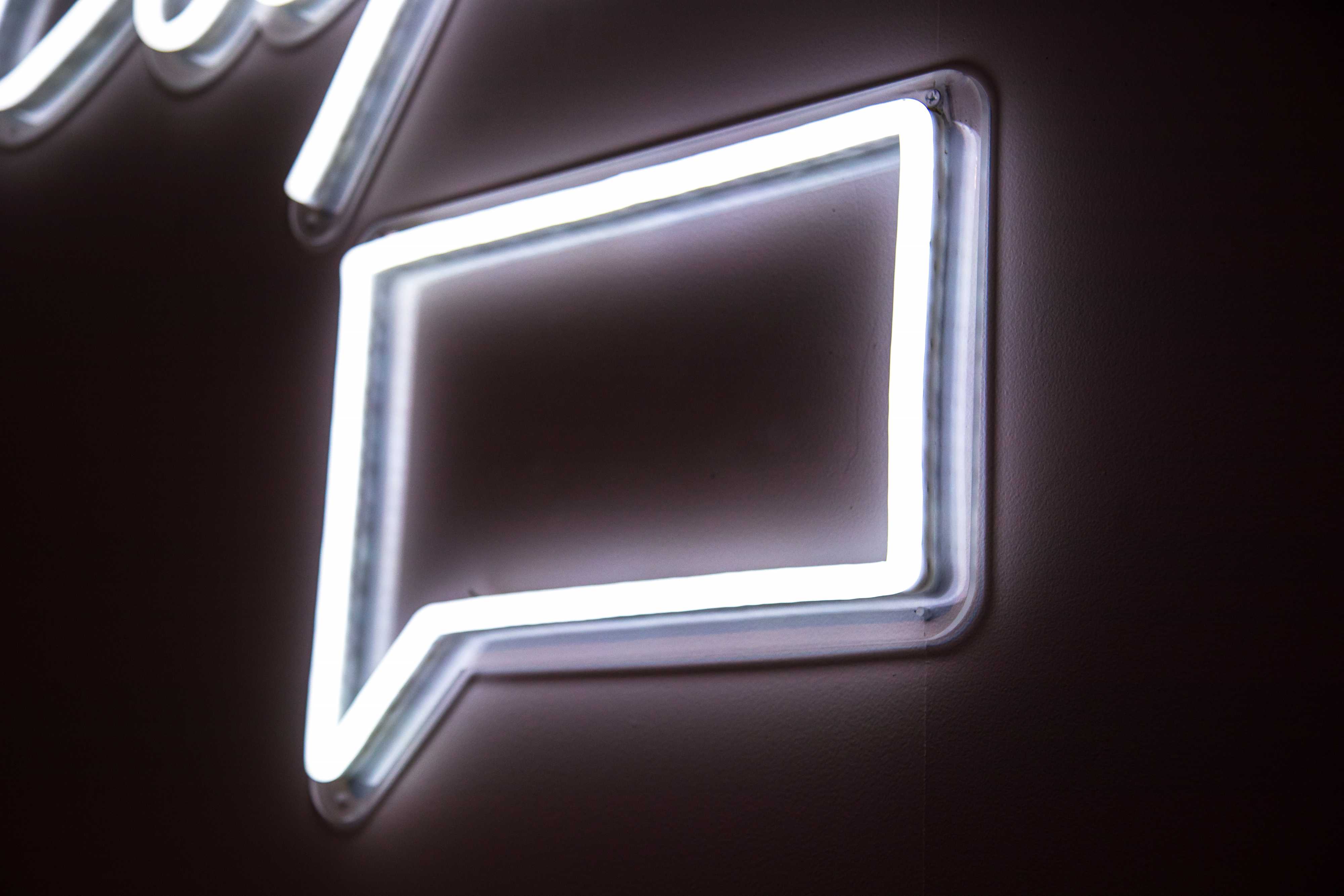 Neon wall sign in shape of email alert